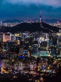 High angle view of city lit up at night