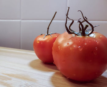 Close-up of wet tomatoes on table