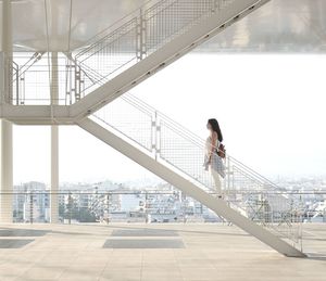 Woman standing on railing