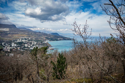 Scenic view of sea and mountains against sky