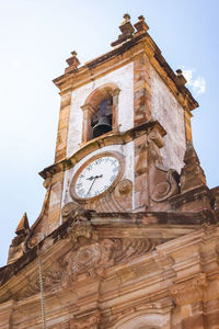 Low angle view of clock tower against sky