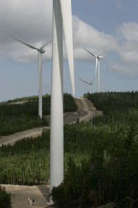 Windmill on field against sky