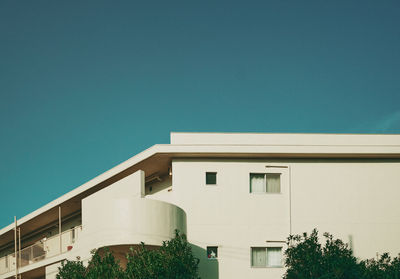 Low angle view of building against clear blue sky