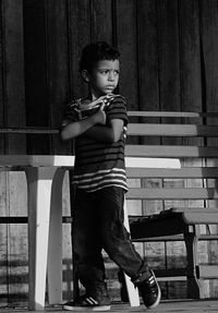 Full length portrait of boy sitting on seat