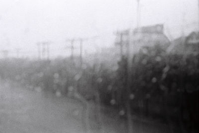 Defocused image of people on glass window