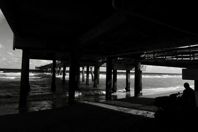 Silhouette of bridge on beach