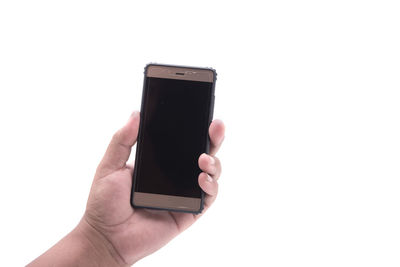 Close-up of hand holding mobile phone over white background