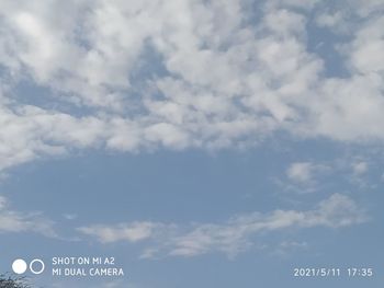 Low angle view of road sign against sky