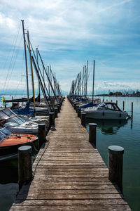 View of pier and boats moored at harbor