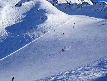 Scenic view of snowcapped mountains on sunny day