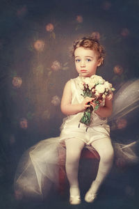 Portrait of a girl sitting on rock