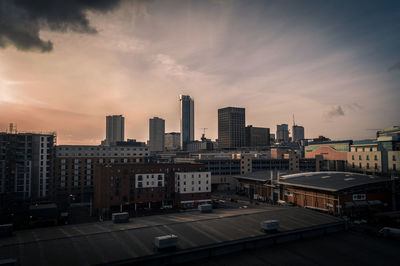 View of cityscape against cloudy sky