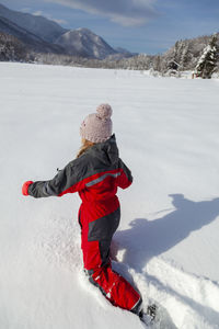 Young girl is having winter fun on a snowy, sunny day in lika, croatia