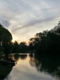 Scenic view of lake against sky at sunset