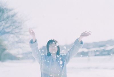 Full length of woman standing in snow