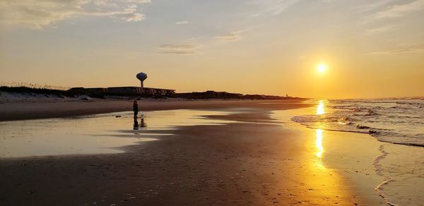 Scenic view of beach against sky during sunset