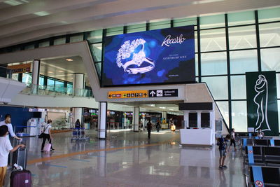 Group of people walking on airport