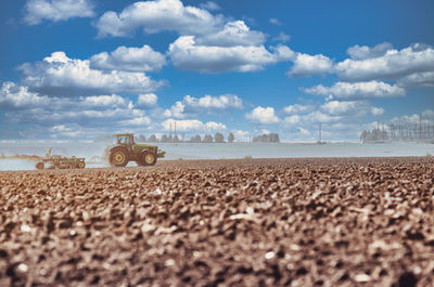 Tractor plowing field. tractor plow soil cultivating. cultivated land and soil tillage. 