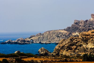 Scenic view of mountain and sea against sky