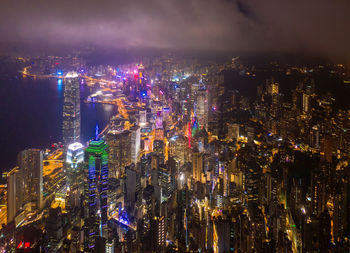 High angle view of illuminated city buildings at night
