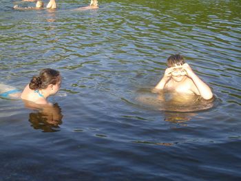 High angle view of people swimming in lake