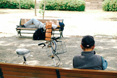 Rear view of man sitting on bench