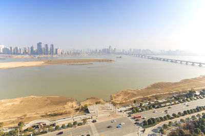 High angle view of river in city against clear sky