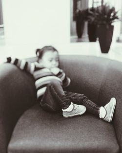 Close-up of boy sitting at home