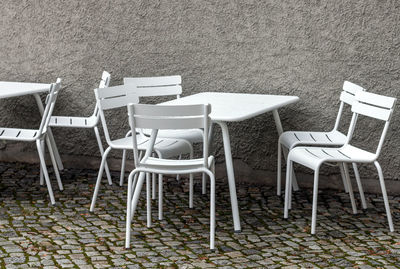 Empty chairs and table on beach