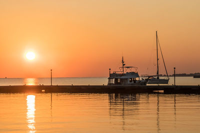 Sailboats in marina at sunset