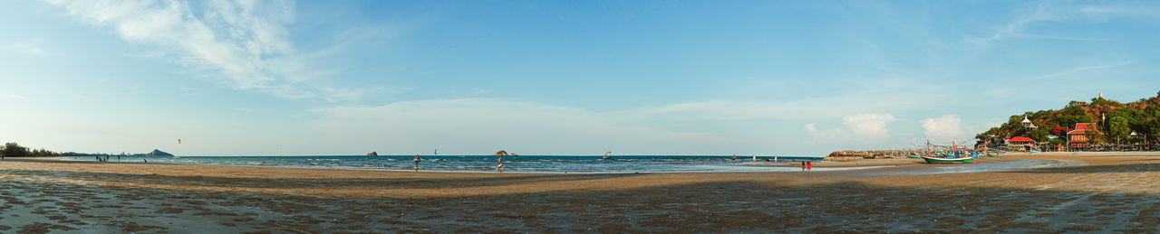 Group of people on beach against sky