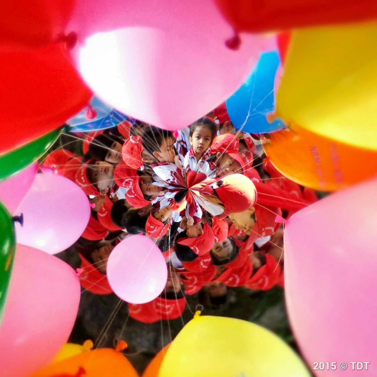 multi colored, indoors, holding, food and drink, food, fruit, leisure activity, close-up, lifestyles, celebration, unrecognizable person, yellow, selective focus, colorful, person, balloon, red, variation