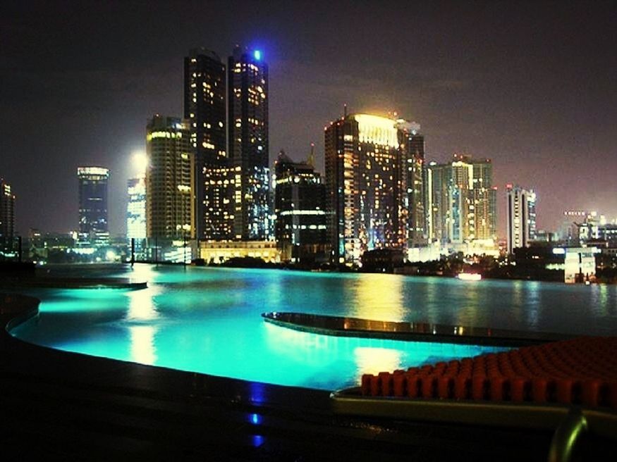 illuminated, city, skyscraper, building exterior, night, architecture, built structure, cityscape, modern, tall - high, urban skyline, office building, tower, financial district, water, skyline, capital cities, waterfront, river, sky