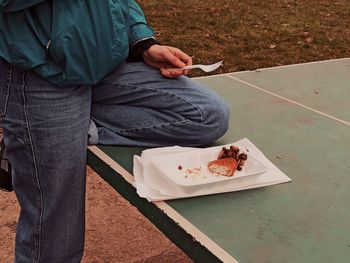 Low section of woman sitting on table