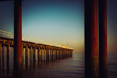 Pier on sea against clear sky