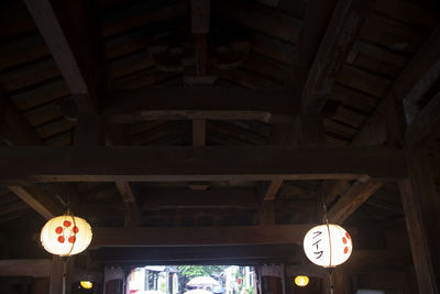 Low angle view of illuminated lanterns hanging from ceiling