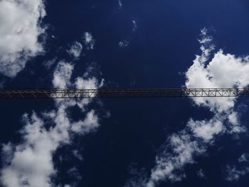 Low angle view of bridge against cloudy sky