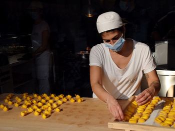 Midsection of man preparing food at store