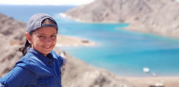 Portrait of smiling girl with beach in background