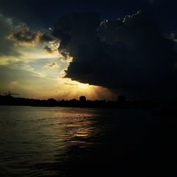 Scenic view of river against sky at dusk