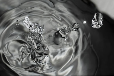 High angle view of drop falling on glass