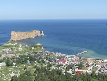 High angle view of townscape by sea against clear sky