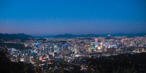 High angle view of illuminated city buildings at night
