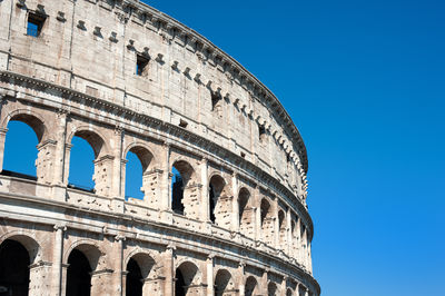 Low angle view of coliseum against sky