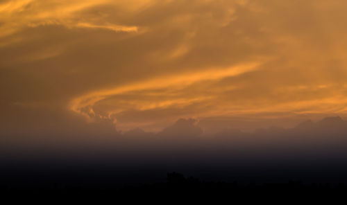 Scenic view of dramatic sky at sunset