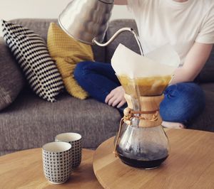 Midsection of man making coffee