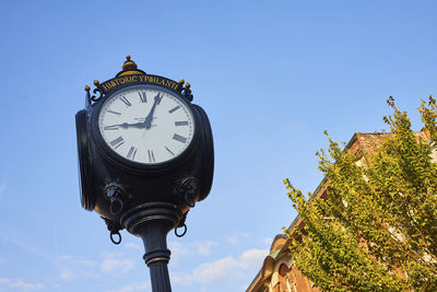 Low angle view of clock tower against clear sky