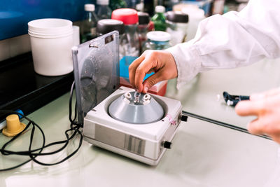 Closeup faceless scientist working in lab