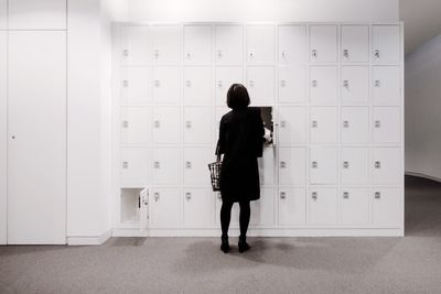 Rear view of man walking in corridor