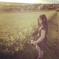 Woman standing on grassy field